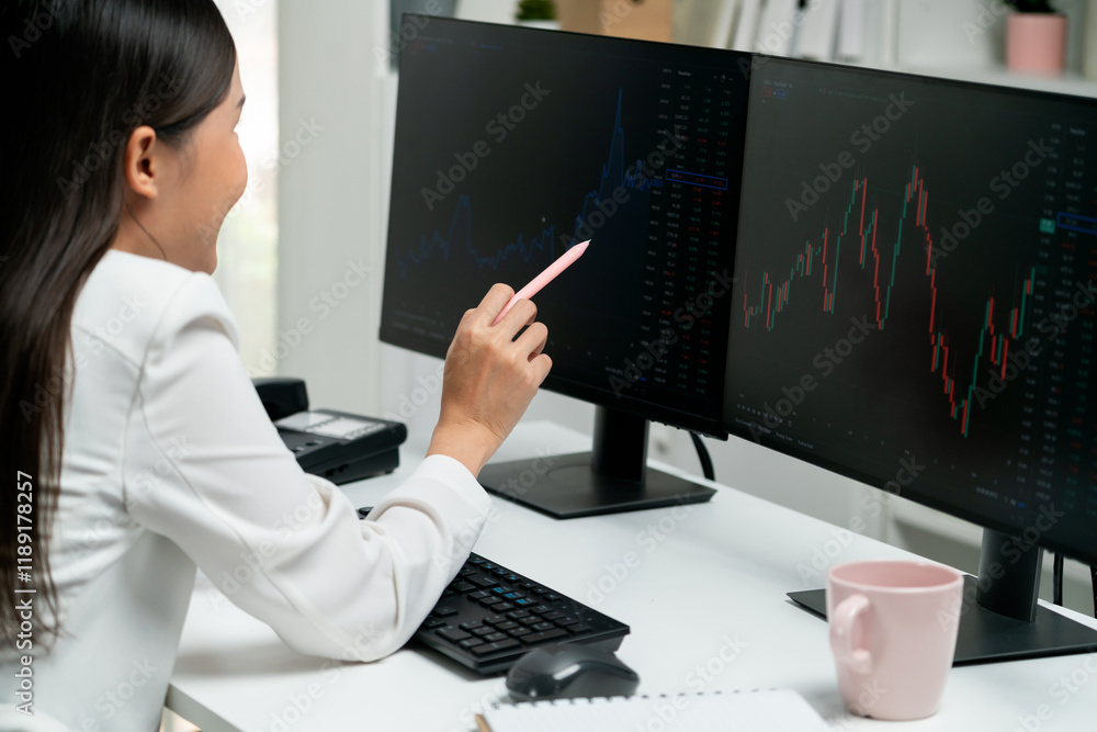 © InfiniteFlow - Young beautiful Asian businesswoman looking on pc to analyze profitable of exchange stock market graph at modern office. Concept of investing high profit in wealth security in finance. Stratagem. © InfiniteFlow - Young beautiful Asian businesswoman looking on pc to analyze profitable of exchange stock market graph at modern office. Concept of investing high profit in wealth security in finance. Stratagem.