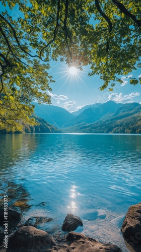 Serene mountain lake landscape with sunlit trees and clear sky