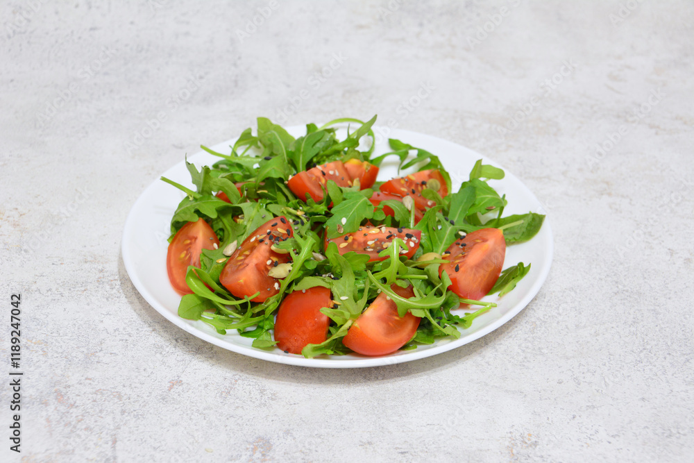 some greenery with seeds and slices of tomato on the plate some greenery with seeds and slices of tomato on the plate