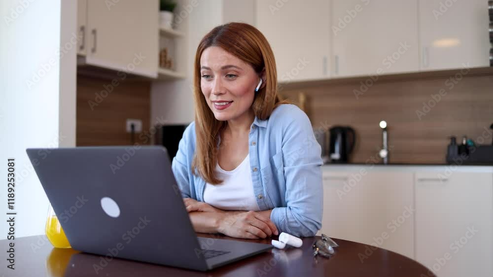 Beautiful woman working online at home and making a video call on her laptop Beautiful woman working online at home and making a video call on her laptop