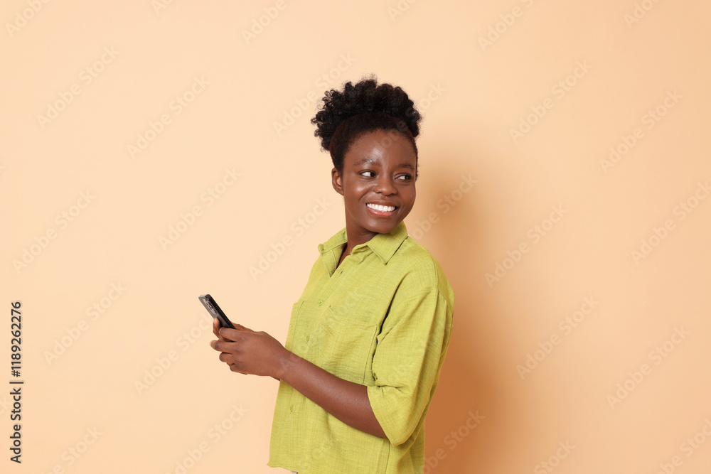 Happy woman with smartphone on beige background Happy woman with smartphone on beige background