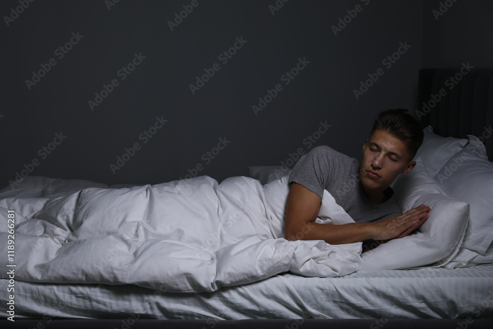 Young man suffering from sleepwalking on bed at home Young man suffering from sleepwalking on bed at home