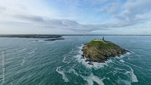 An aerial view of Ballycotton Lighthouse, perched on its rugged island, surrounded by the vast Atlantic Ocean