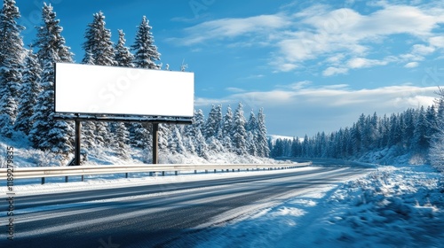 Blank billboard on snowy winter road through coniferous forest