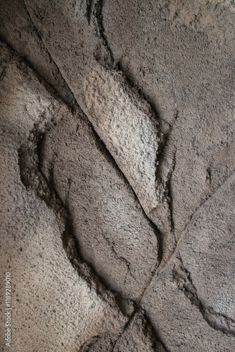 Abstract dark style whimsical patterns on sandstone in cave, background closeup