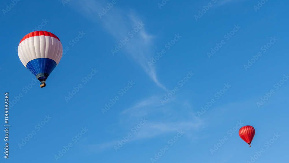 Two hot air balloons flying in the blue sky Two hot air balloons flying in the blue sky