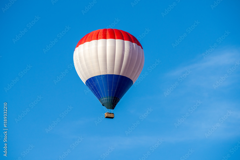 Obraz premium Flying colorful hot air balloon in the blue sky