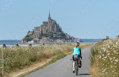 Solo female traveler cycling around mount San Michele.