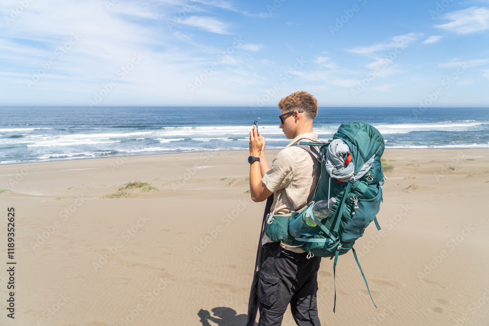 Young Backpacker Taking a Photo of the Landscape