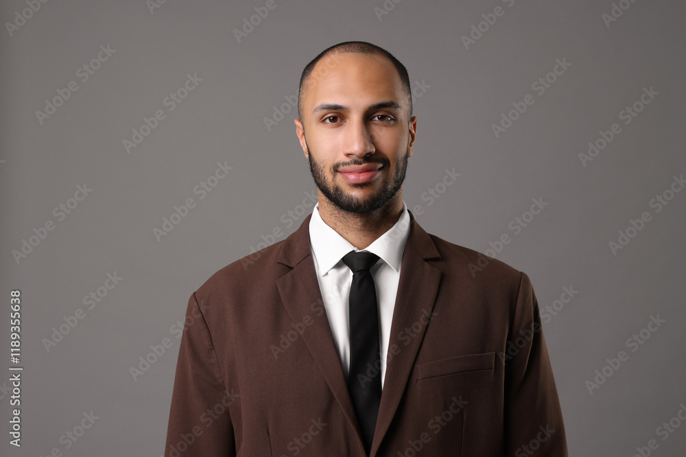Portrait of businessman in brown jacket on gray background Portrait of businessman in brown jacket on gray background