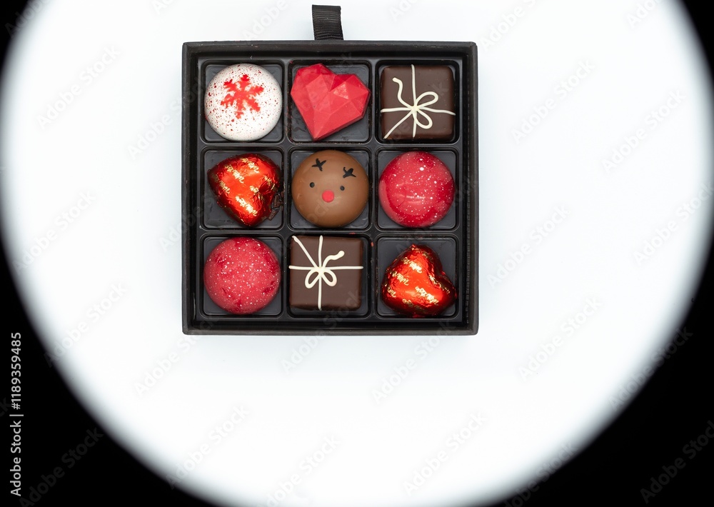 Box with handmade chocolates on a white and black background, Valentine's Day. Box with handmade chocolates on a white and black background, Valentine's Day.