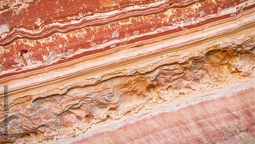 Vibrant multicolored sandstone layers with intricate erosion patterns resembling a desert canyon wall photo