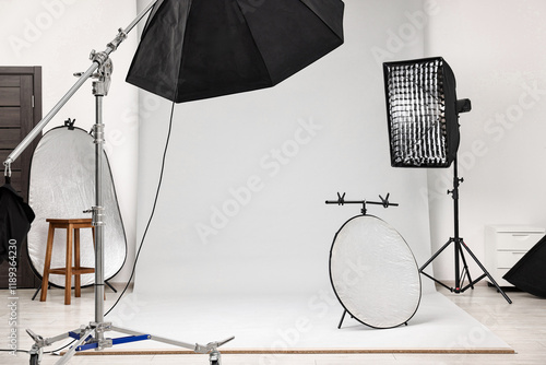 Professional lighting equipment setup in modern photo studio