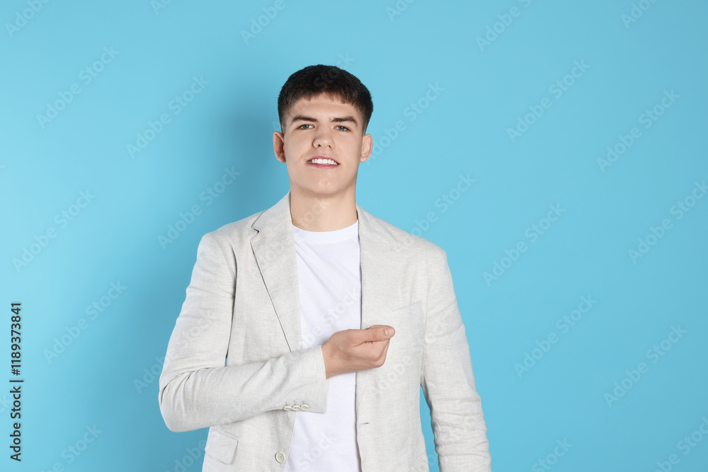 Man making promise on light blue background. Oath gesture Man making promise on light blue background. Oath gesture