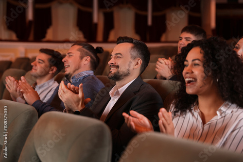 Konstfotografi Group of exited people applauding in theatre
