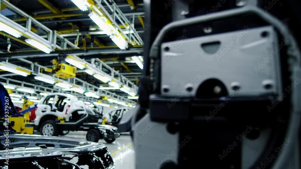 Engineer worker in automotive factory car manufacturing process, assembly line production Engineer worker in automotive factory car manufacturing process, assembly line production