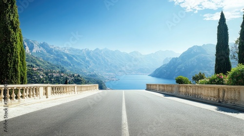 dramatic perspective of empty road stretching toward distant mountains under clear blue sky photo