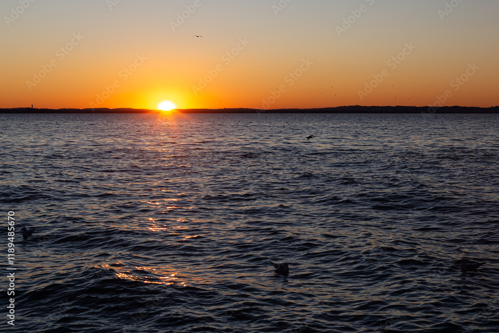 Lake Garda: fiery sunset on the mountains from Lazise.