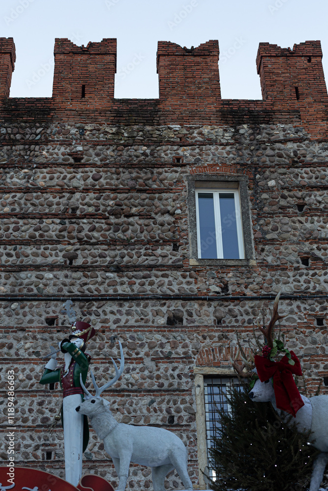 Verona: Christmas market with reindeer and historic castle.