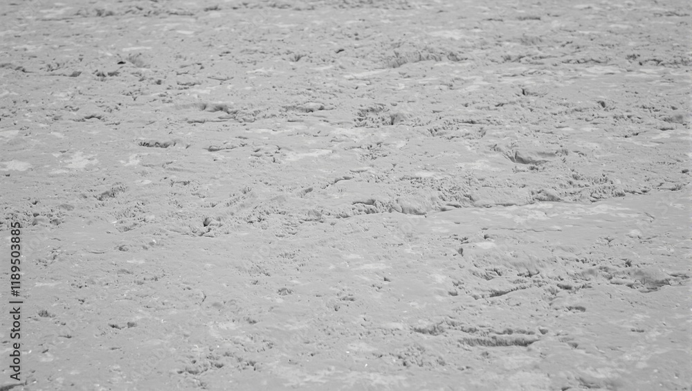 Fototapeta premium Close up of wet concrete with smooth ridges ripples and aggregate peeking through