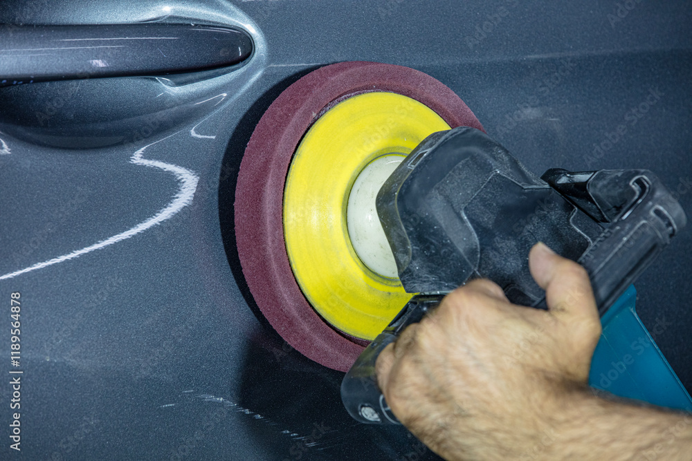 Car polish wax worker hands applying protective tape before polishing. Buffing and polishing car. Car detailing. Man holds a polisher in the hand and polishes the car. Car polish wax worker hands applying protective tape before polishing. Buffing and polishing car. Car detailing. Man holds a polisher in the hand and polishes the car.