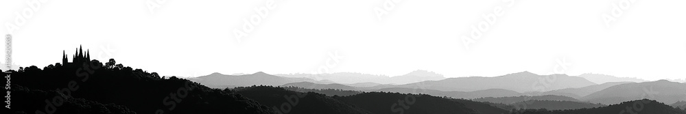 Silhouette of a Gothic castle against a misty mountain landscape in black and white. Silhouette of a Gothic castle against a misty mountain landscape in black and white.