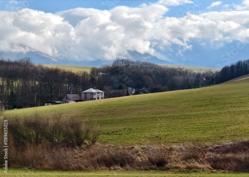 hilly agricultural landscape with field and houses photo