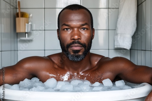 Close-up of man in an ice bath in a tiled bathroom photo