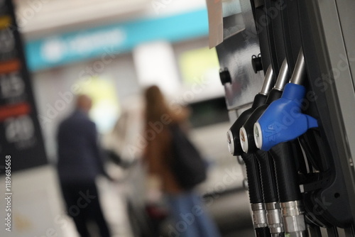 Detalle de surtidor con diferentes mangueras de tipo de gasolina en una gasolinera. Referencia a combustible fósil contaminante. Petróleo  photo