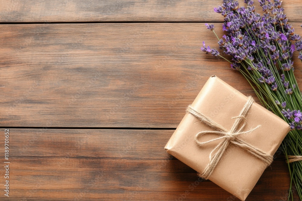 Rustic kraft package with jute string beside fresh lavender on wooden table Rustic kraft package with jute string beside fresh lavender on wooden table