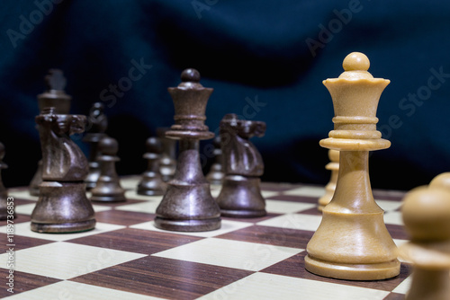 Chessmen photographed on a chessboard with a dark background
