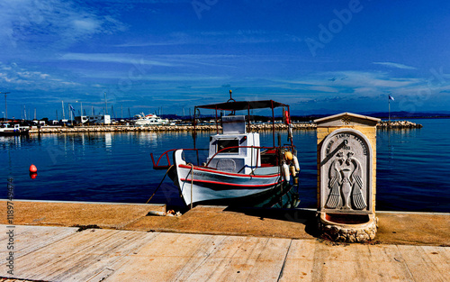 Fishing Boat and Peacock Fountain in Katakolo Greece photo