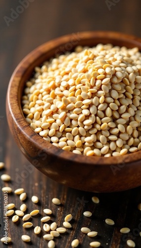 Sesame seeds scattered all over the surface of a wooden bowl, sesame seeds, surface, brown photo