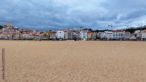Drone view showcasing the stunning coastline of Nazaré, Lisbon, Portugal, with its sandy beach, picturesque cityscape, and breathtaking scenery, highlighting the charm of this coastal destination