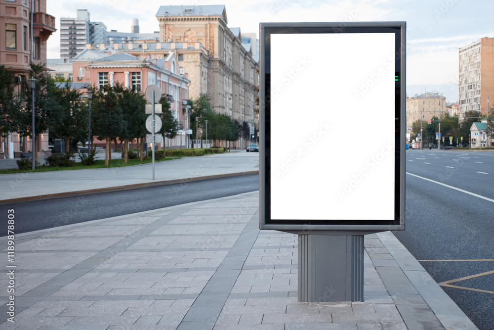 White empty vertical billboard on a clean and tidy street in Moscow. Mock-up. White empty vertical billboard on a clean and tidy street in Moscow. Mock-up.