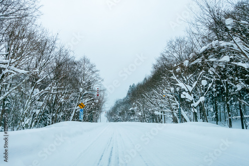 Hokkaido Bibai-Furano Line Rd 135 covered with snow in winter,the Japanese on the traffic sign reads 
