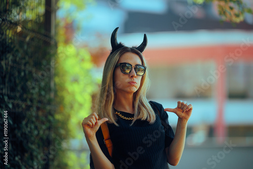 Selfish Devilish Woman Pointing to Herself being Obnoxious . Evil mean girl being self-obsessed egocentrioc snob 
