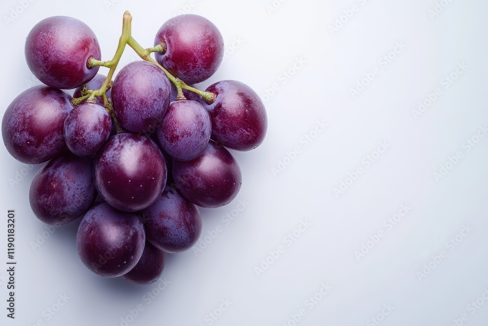 A cluster of fresh grapes is elegantly arranged on a wooden table, showcasing their vibrant color and natural beauty. A cluster of fresh grapes is elegantly arranged on a wooden table, showcasing their vibrant color and natural beauty.