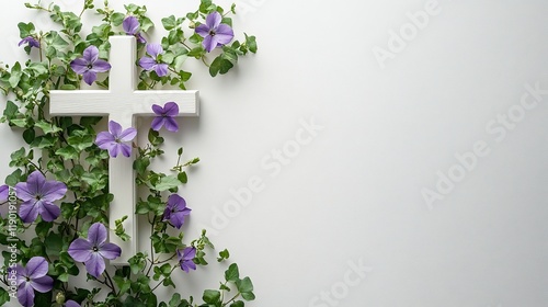 A simple white cross with green leaves and purple flowers on the left side of a plain white background