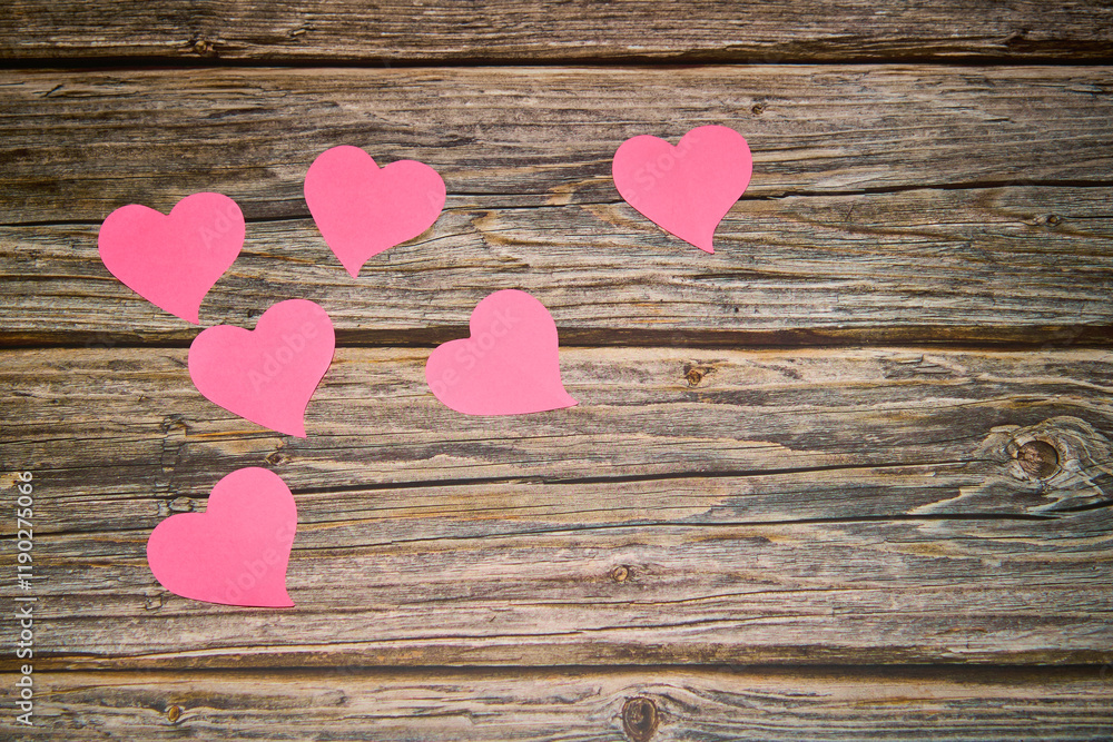 pink hearts on a rustic wooden table pink hearts on a rustic wooden table