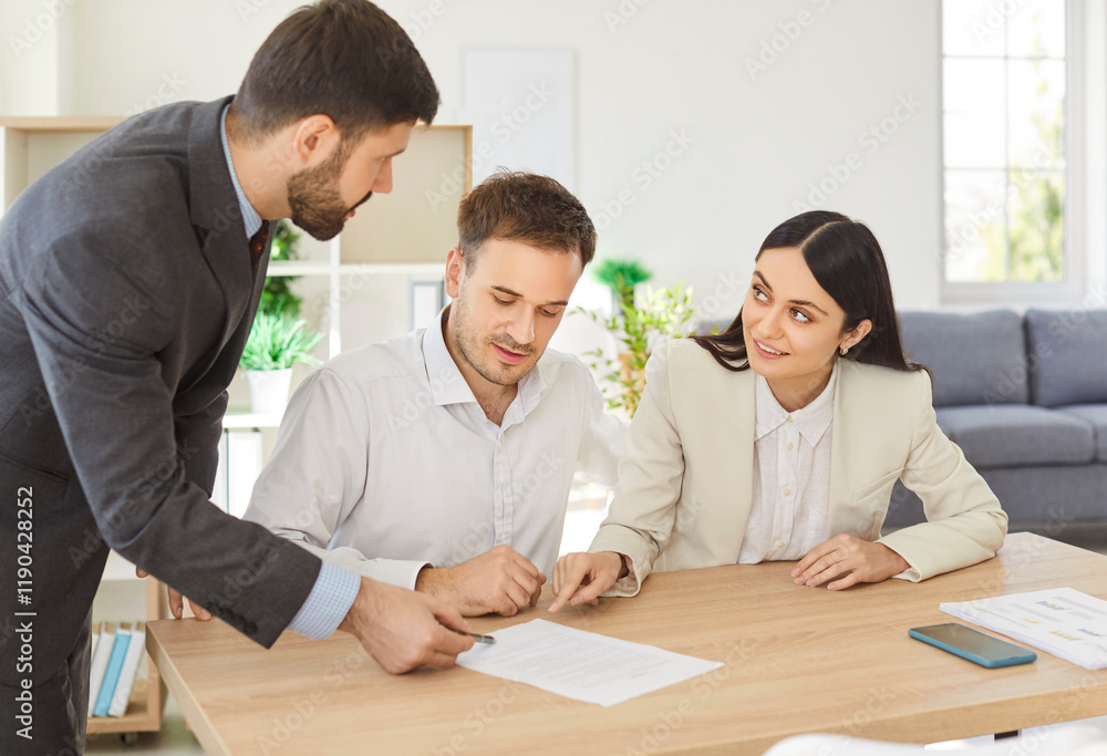 Business people colleagues sitting at the desk on workplace in office discussing new project, reaching agreement and going to sign a contract making a deal. Partnership and teamwork concept. Business people colleagues sitting at the desk on workplace in office discussing new project, reaching agreement and going to sign a contract making a deal. Partnership and teamwork concept.