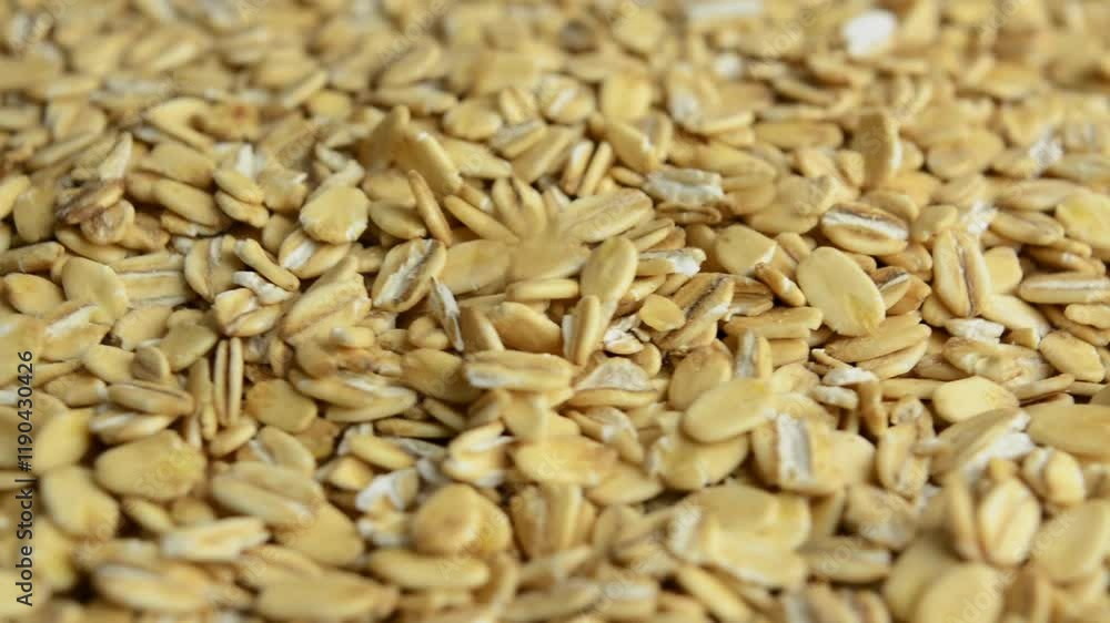 Oatmeal rotates, side view. Slow rotation. Raw rolled oats. Porridge is poured on top. Oatmeal rotates, side view. Slow rotation. Raw rolled oats. Porridge is poured on top.
