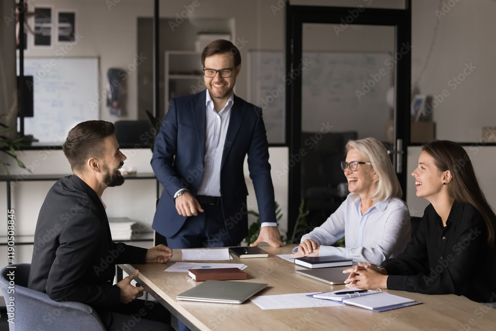 © fizkes - Happy business team participate in meeting, laughing, lead talk in light-hearted and positive atmosphere, sharing creative solutions and ideas enjoy productive, collaborative and successful teamwork