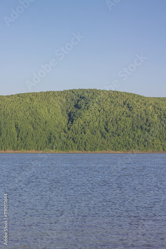 Landscape of the river and mountains on a background of blue sky photo