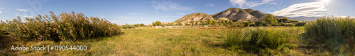 A breathtaking panoramic view of a stunning landscape with rolling hills and vibrant greenery photo