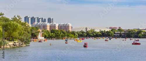 Panorama of pedal boats in front of the Olympic Center in Shuishang Park, Tianjin, China photo