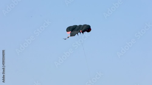 huge black paraglider kite in the sky, ahmedabad India photo