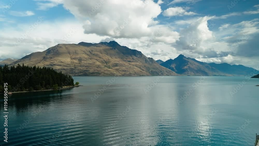 Aerial Forward Shot Of Rippled Lake Amidst Tranquil Mountains Under Cloudy Sky - Queenstown, New Zealand Aerial Forward Shot Of Rippled Lake Amidst Tranquil Mountains Under Cloudy Sky - Queenstown, New Zealand