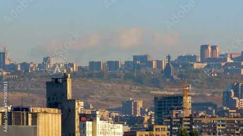 Wallpaper Mural A time-lapse video of an urban landscape during the day, with moving clouds, small cars. Against a backdrop of buildings, a hill, blue sky and trees. Torontodigital.ca
