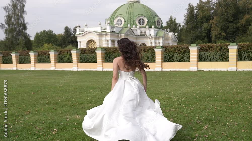 A joyful bride in a stunning white dress twirls in a lush garden A joyful bride in a stunning white dress twirls in a lush garden